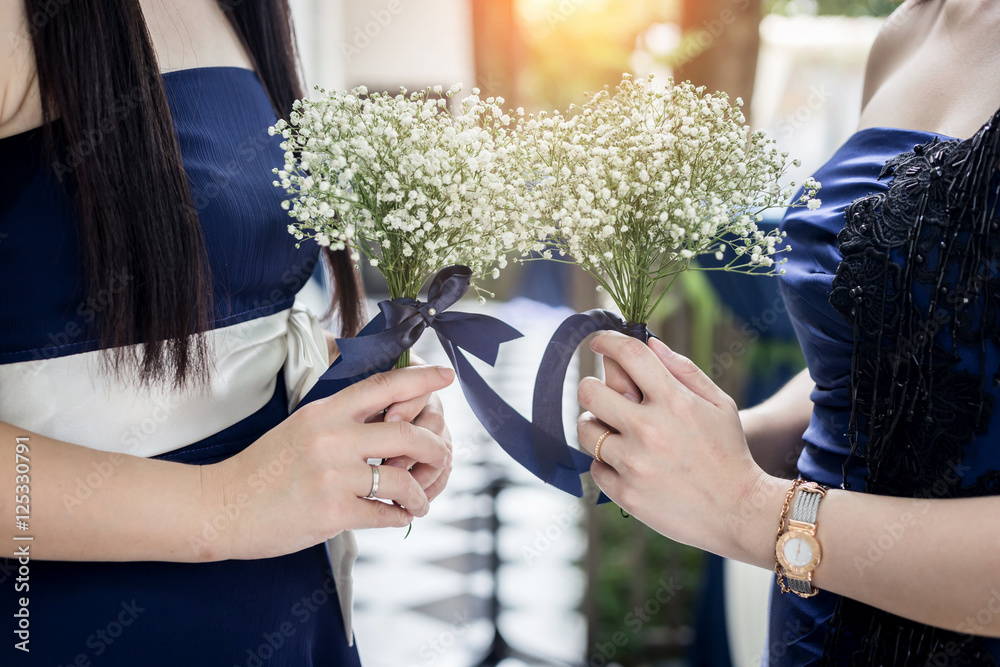 closed up womans hand hold tiny beautiful white flower