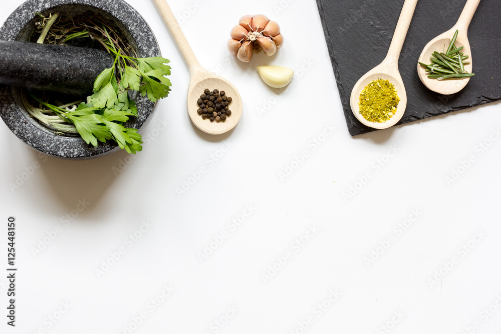 spices for cooking with pounder on white background top view