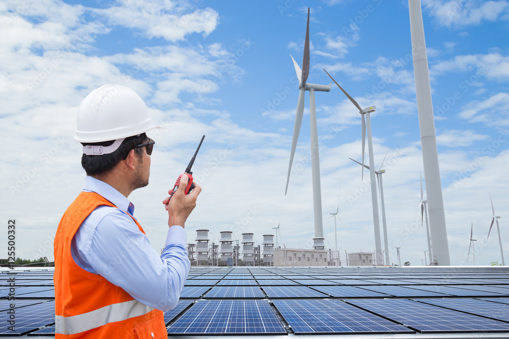 Engineers working at wind turbine power generator station