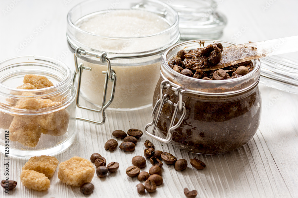 homemade coffe scrub in glass jar on wooden background