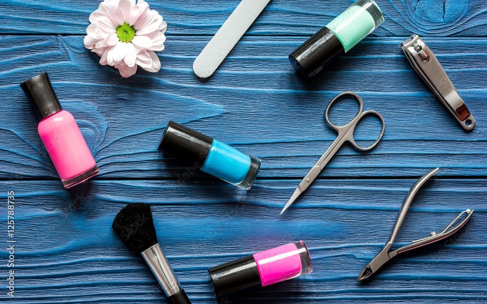 flower, nail polish and manicure set on dark wooden background