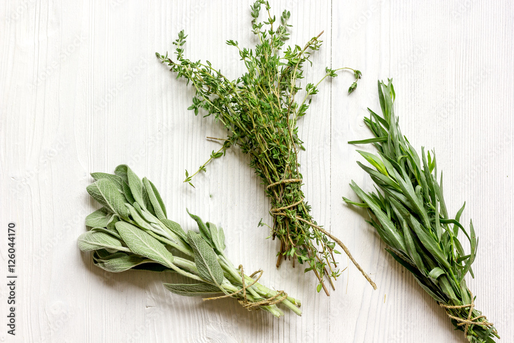 bundles of herbs on wooden background top view