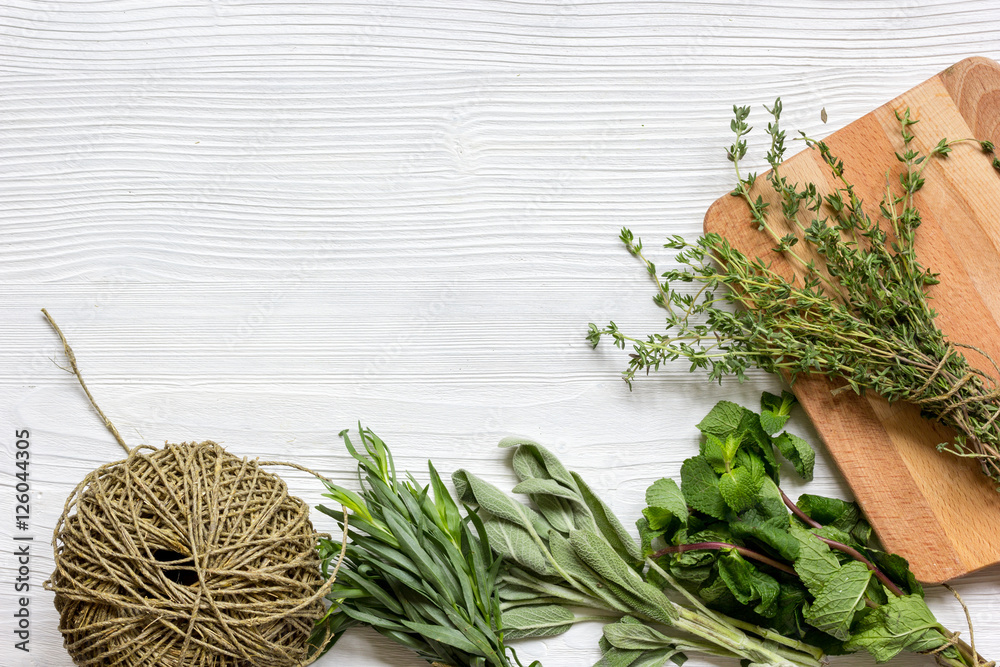 fresh herbs preparation to be dried top view wooden background