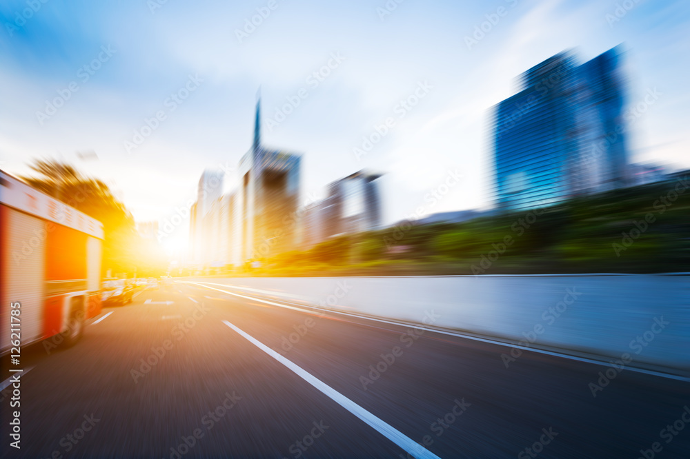 modern buildings in guangzhou from empty asphalt at sunrise