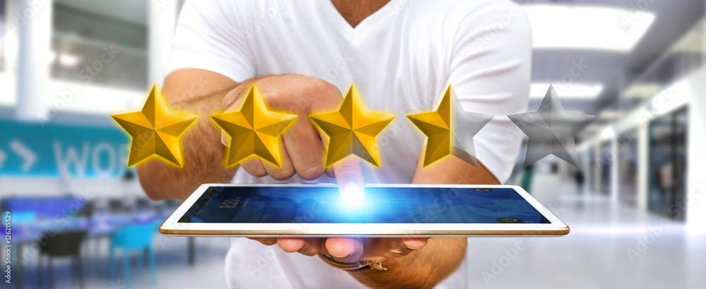 Businessman rating stars with his tablet