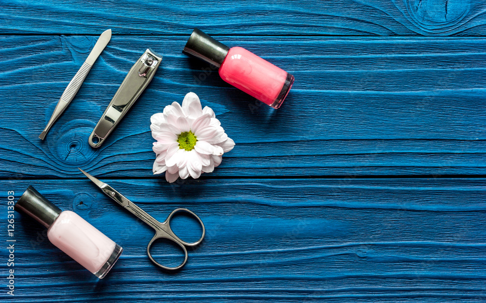 nail polish and spa manicure set on dark wooden background