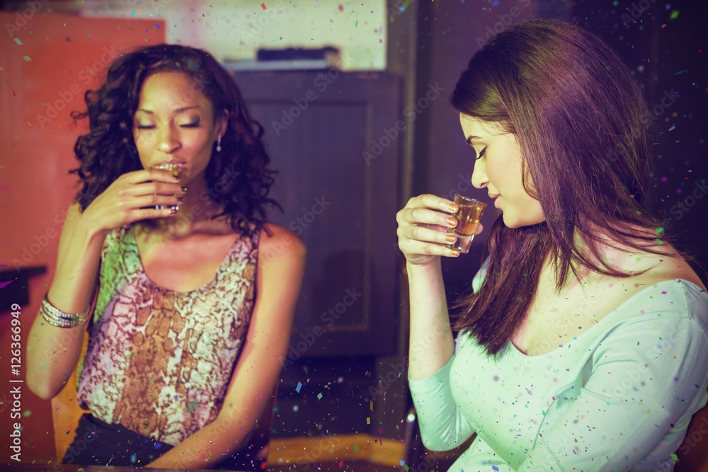 Composite image of two women having tequila