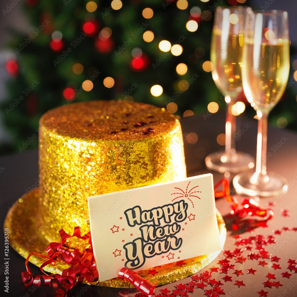  Digital composite of Happy new year card leaning on gold party hat