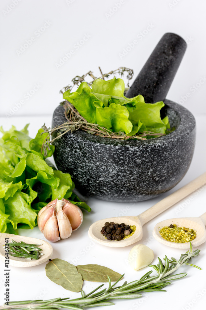 spices for cooking with pounder on white background close up