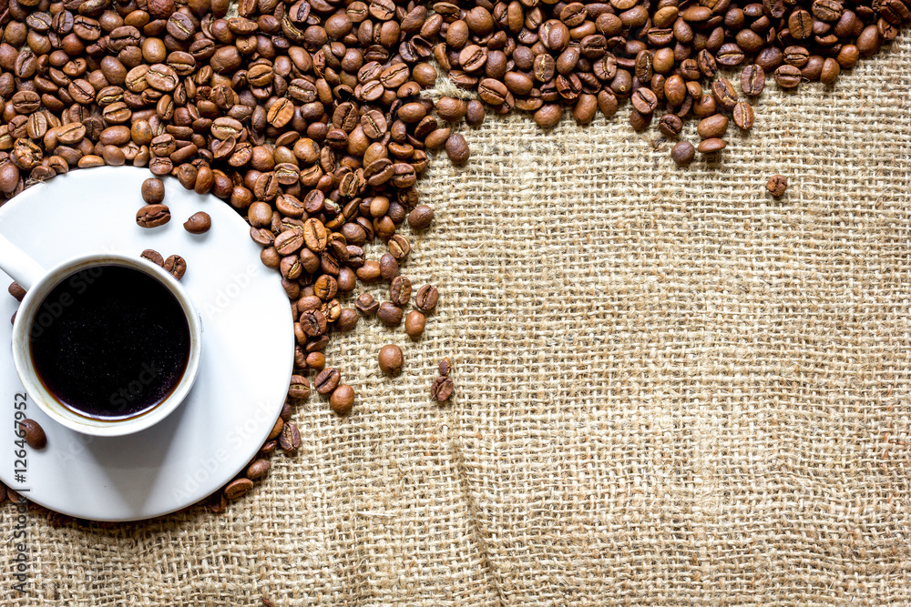 coffee beans, coffe cup on linen cloth background top view