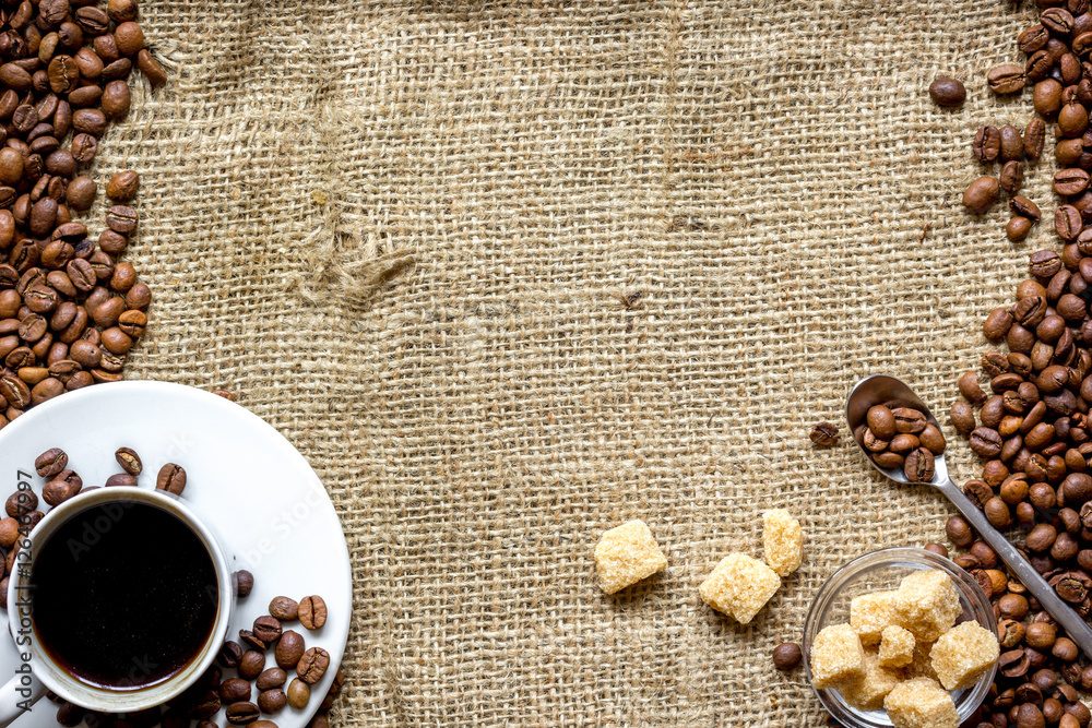 coffee beans, coffe cup on linen cloth background top view