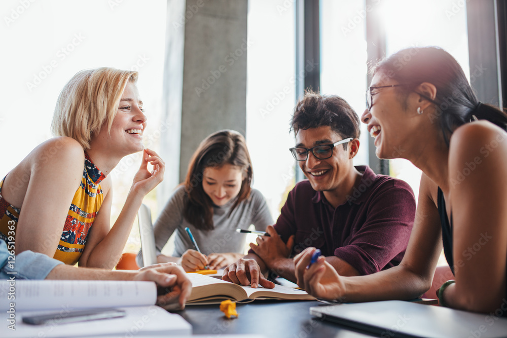 Multiethnic young people studying at school library