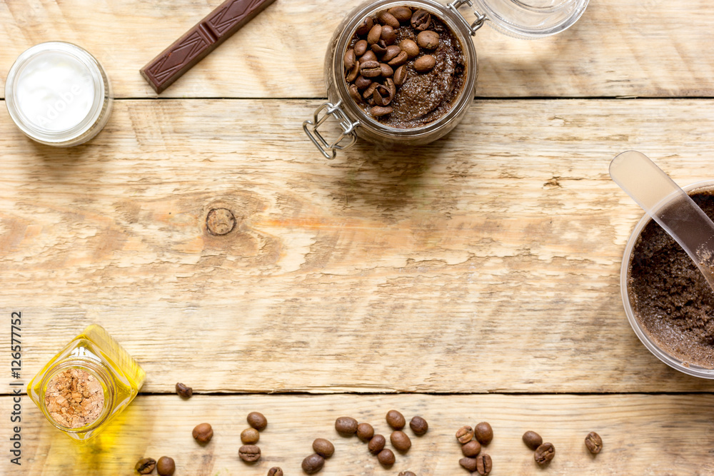 Body scrub of ground coffee top view on wooden table