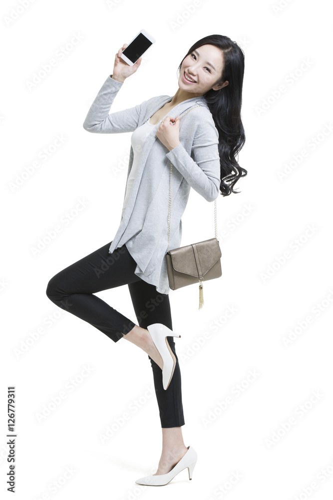 Happy young woman showing a smart phone