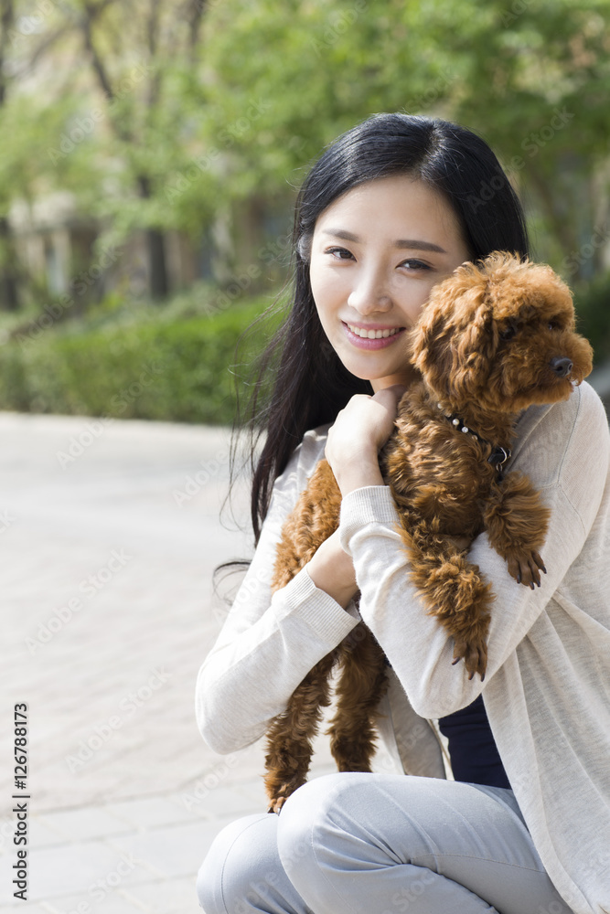 Happy young woman with her pet dog