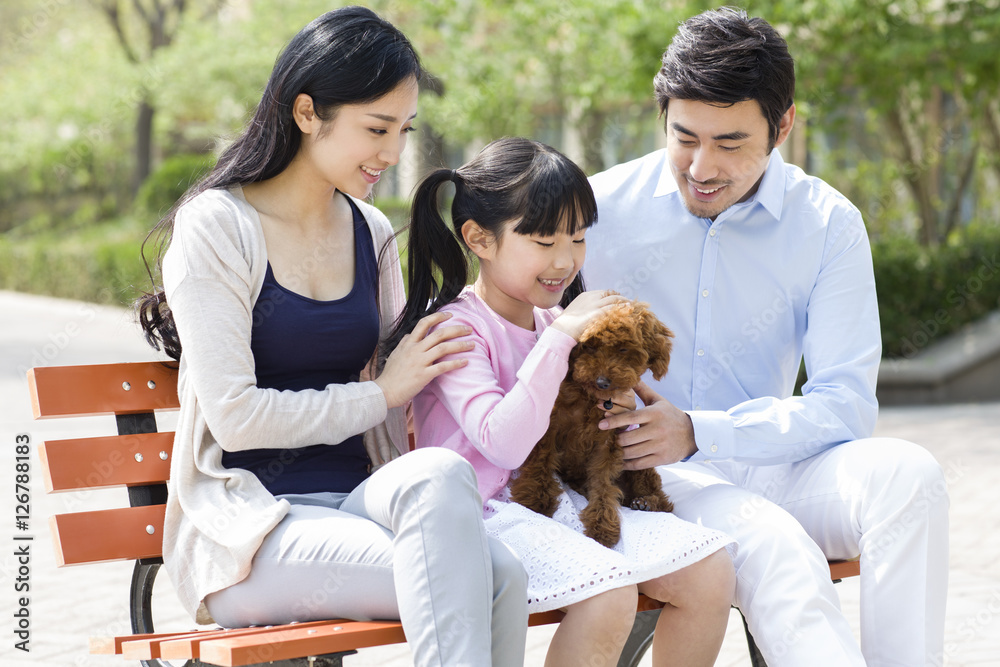 Happy young family with their pet dog