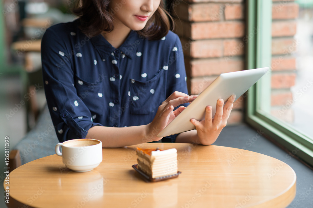 Beautiful cute asian young businesswoman in the cafe, using digi