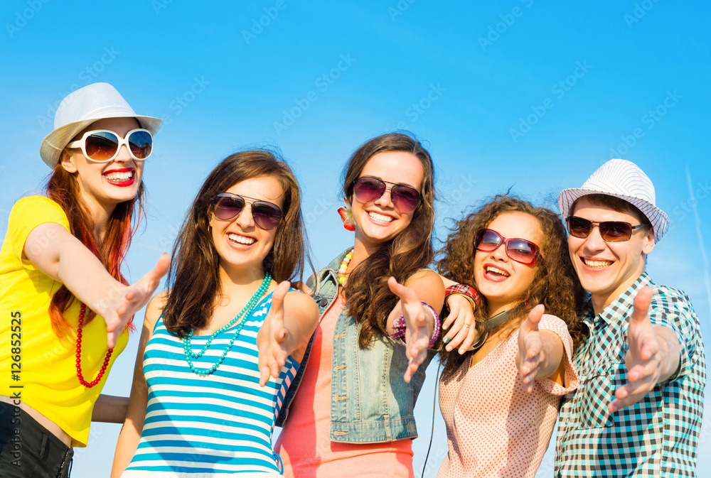 group of young people wearing sunglasses and hat