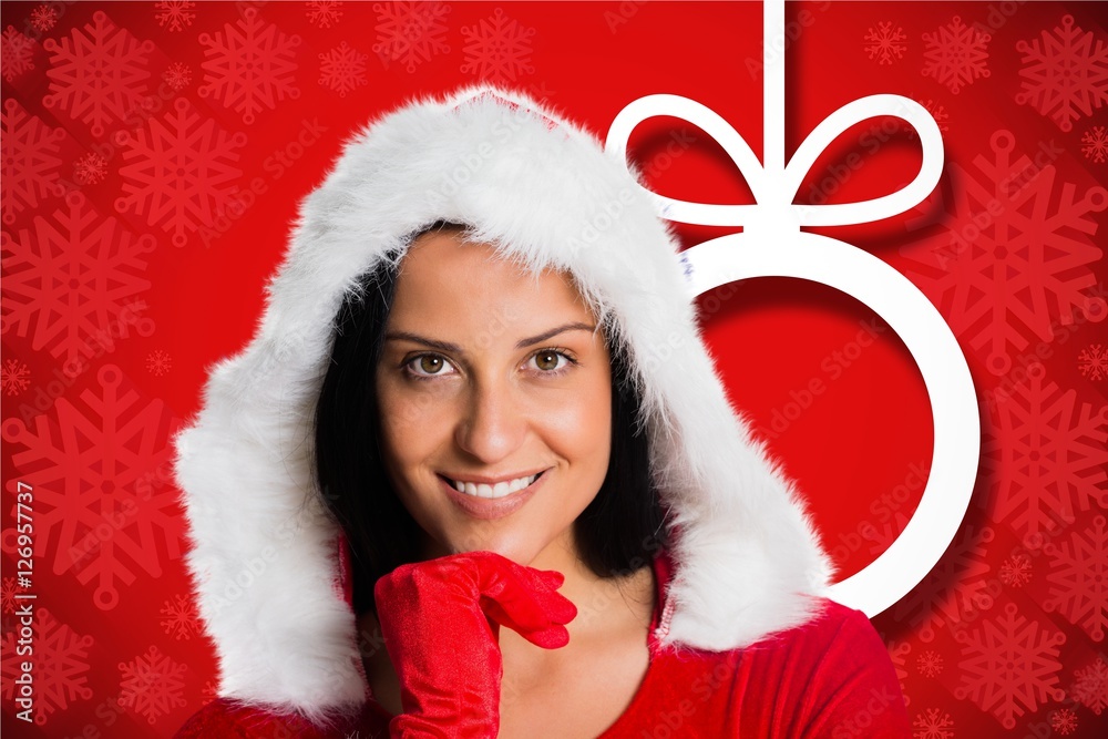 Beautiful woman in santa hat with hand on chin