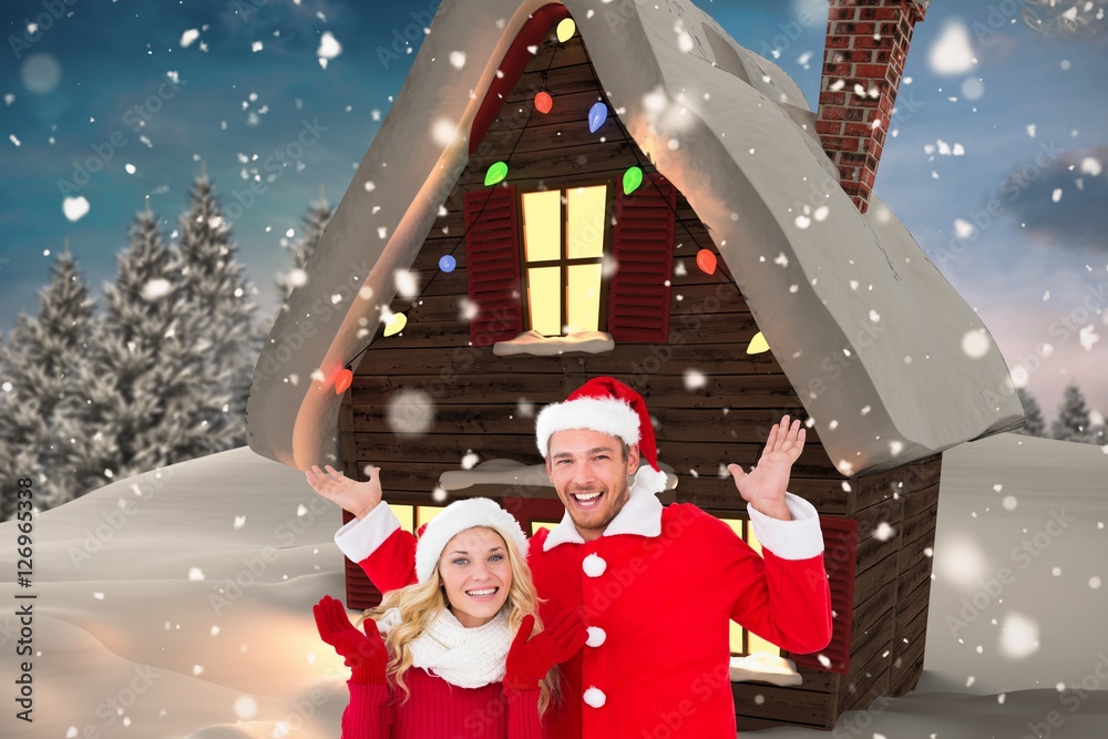 Happy couple in santa costume gesturing against digitally genera