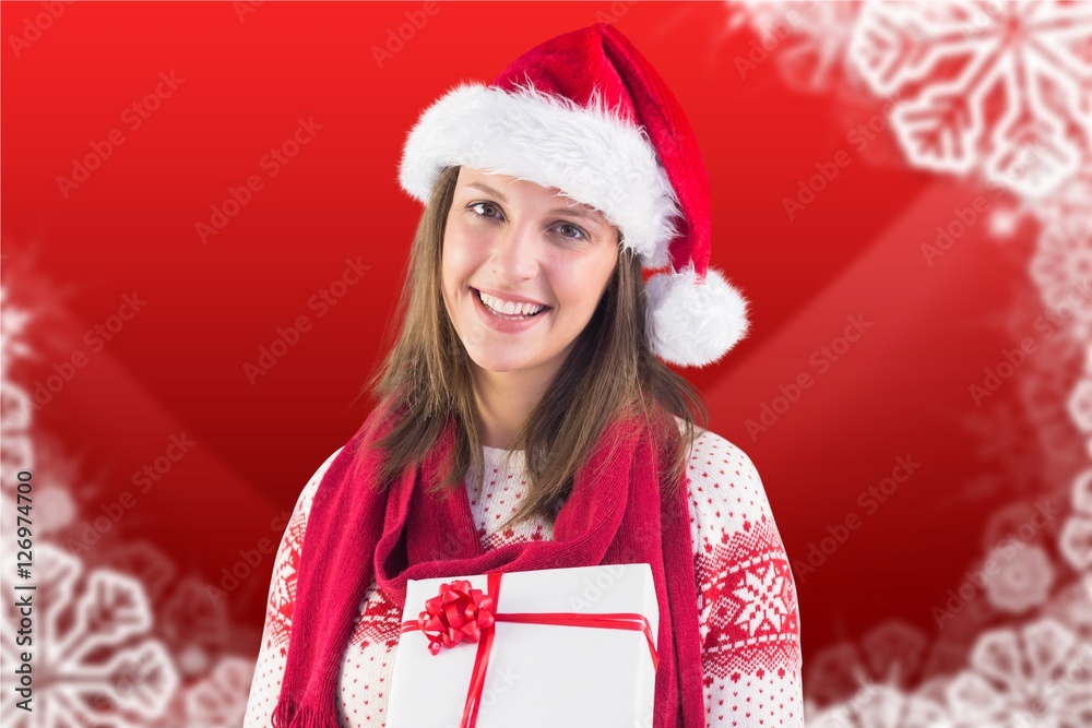 Beautiful woman in santa hat holding a christmas gifts