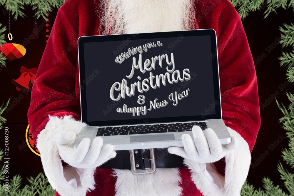 Santa claus showing lap top with christmas greeting