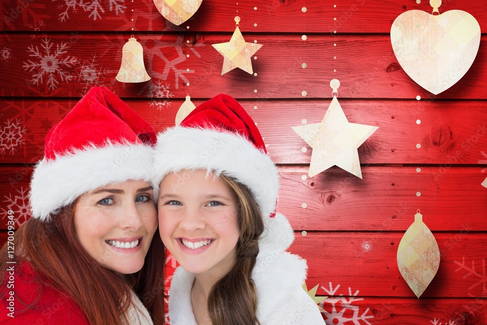 Portrait of mother and daughter in santa hat against digitally g