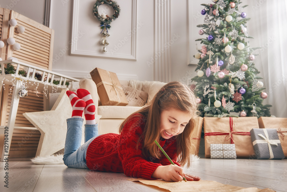 girl writes the letter to Santa Claus