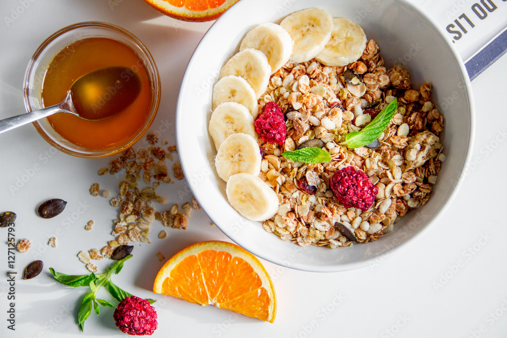 Breakfast with oatmeal and orange juice on white background