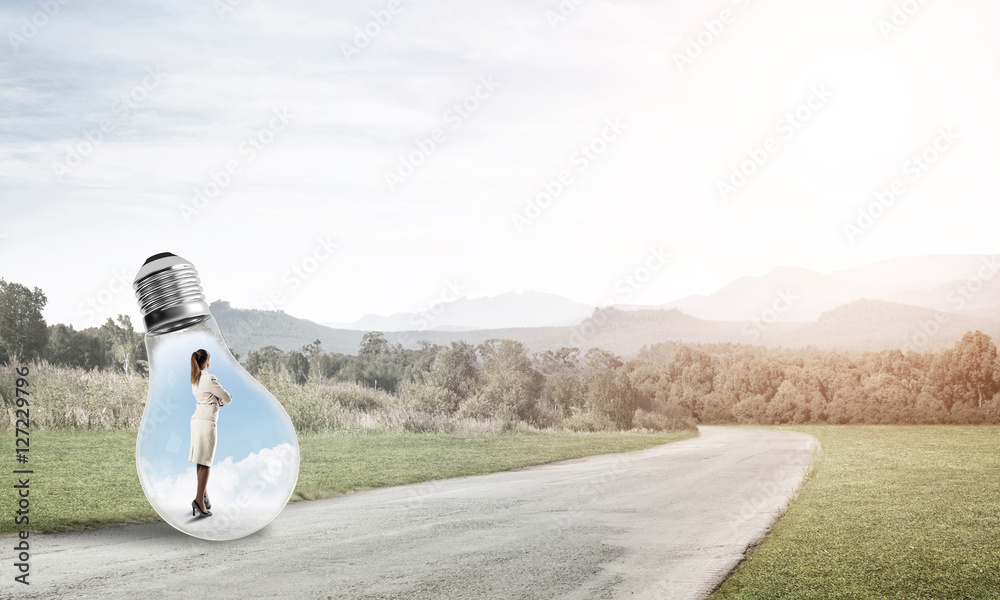 Businesswoman inside light bulb