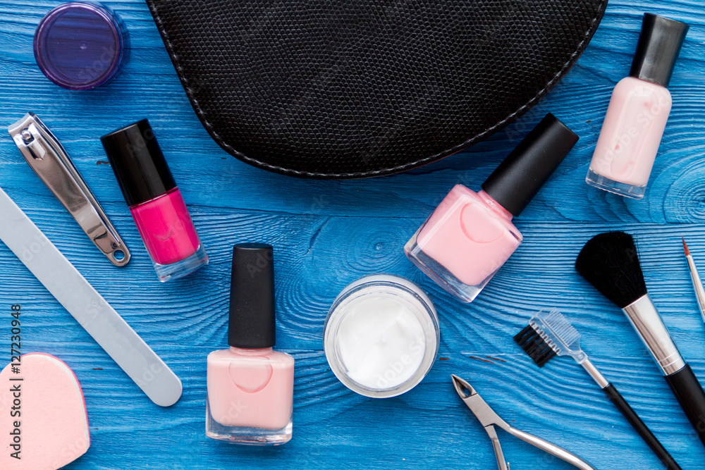 cosmetic and manicure set on wooden background top view