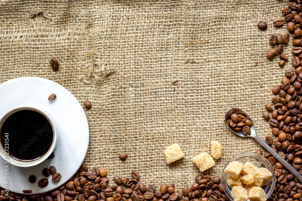 coffee beans, coffe cup on linen cloth background top view