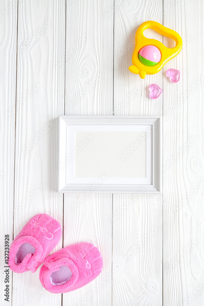 baby shower - blank picture frame on wooden background