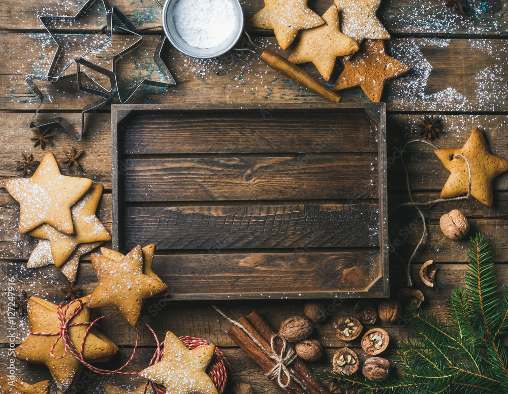 Christmas, New Year background. Gingerbread cookies, sugar powder, nuts, spices, baking molds, fir-t