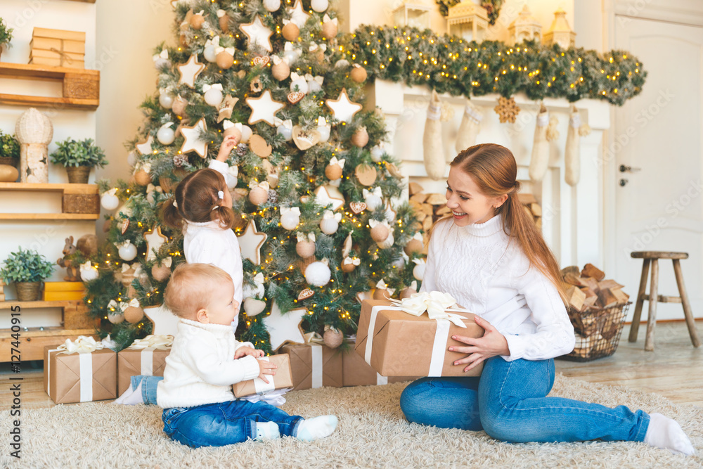 happy family mother and two children on Christmas morning  tree