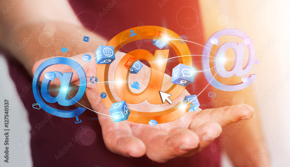 Businessman holding 3D rendering email icon in his hand