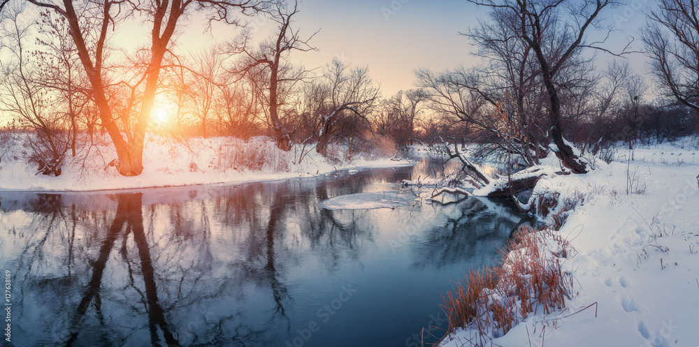 Panoramic winter landscape with trees, beautiful river at sunset. Winter forest. Season. Scenery wit