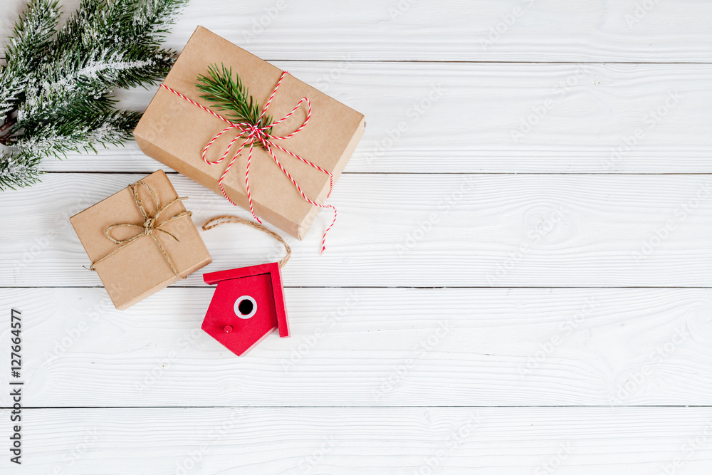 gifts boxes with fir branches on wooden background top view