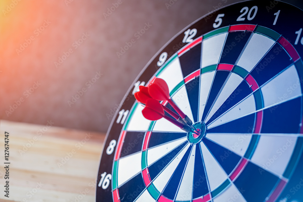 Right on target concept using dart in the bullseye on dartboard