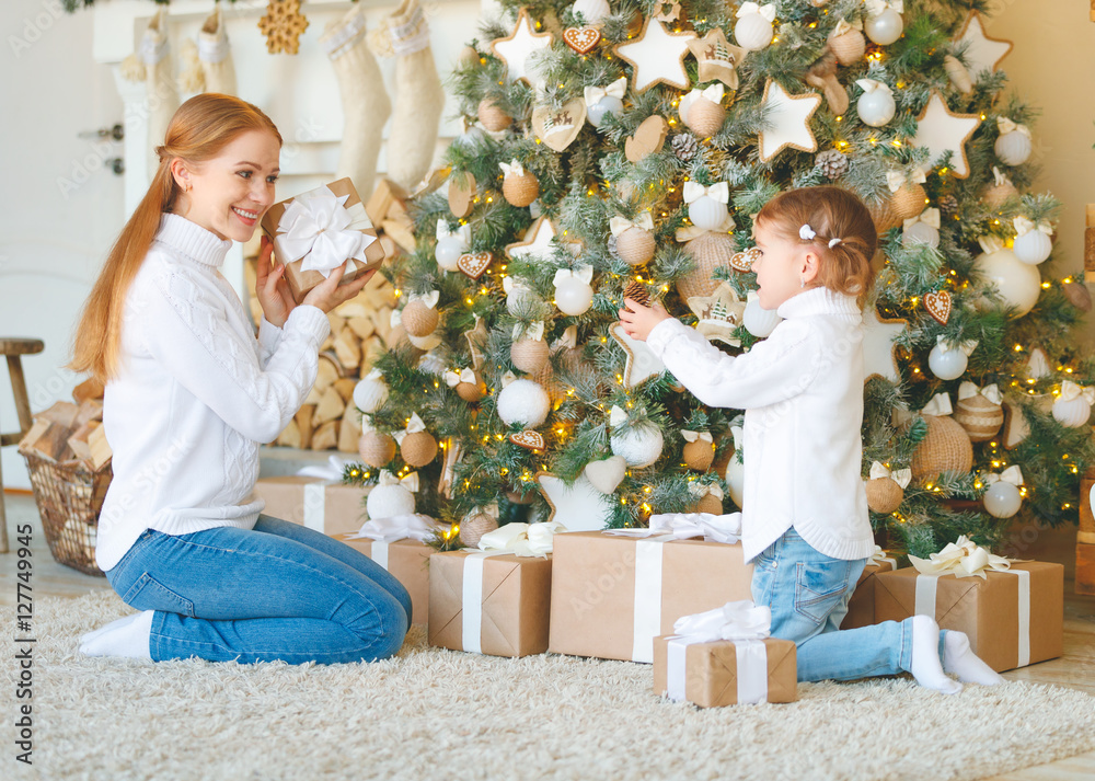 happy family mother and child daughter on Christmas morning  tre