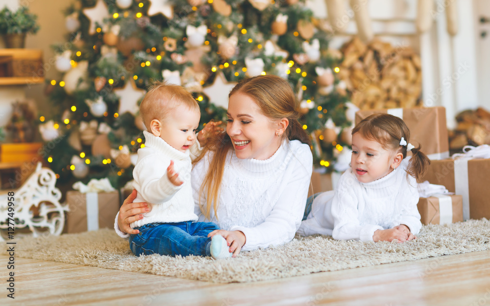 happy family mother and two children on Christmas morning  tree