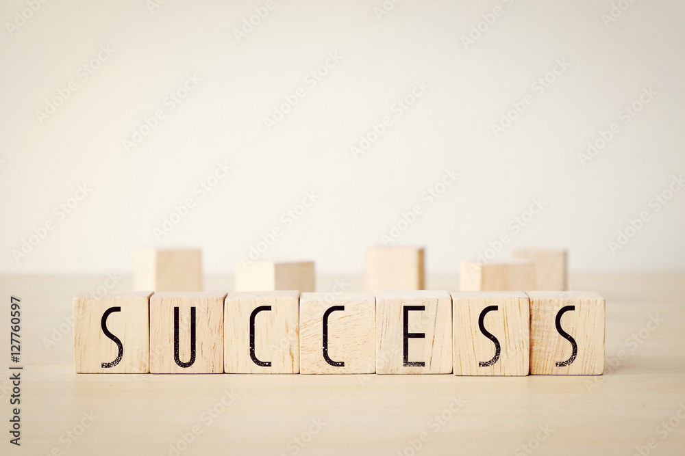 Sucess word on wooden cubes background