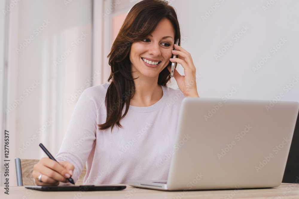 Beautiful young woman working from home.