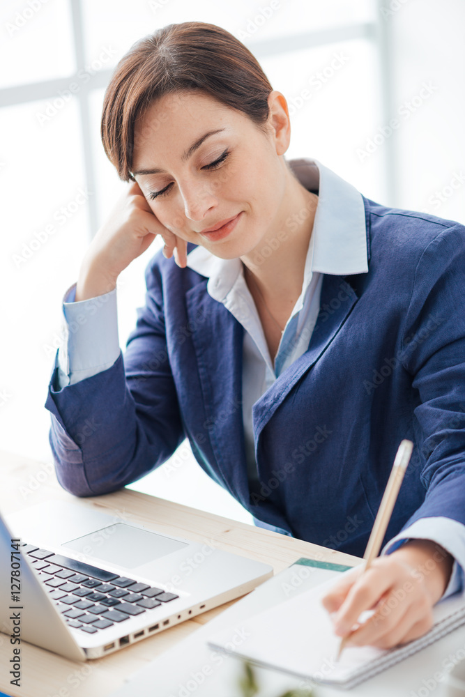 Secretary writing notes on a notebook