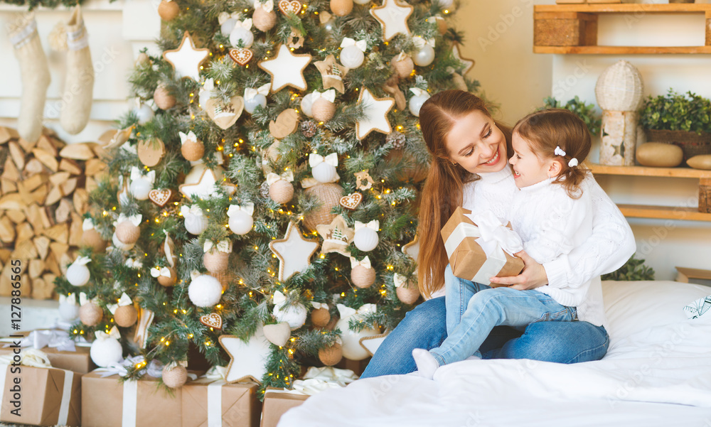 happy family mother and child daughter on Christmas morning  tre