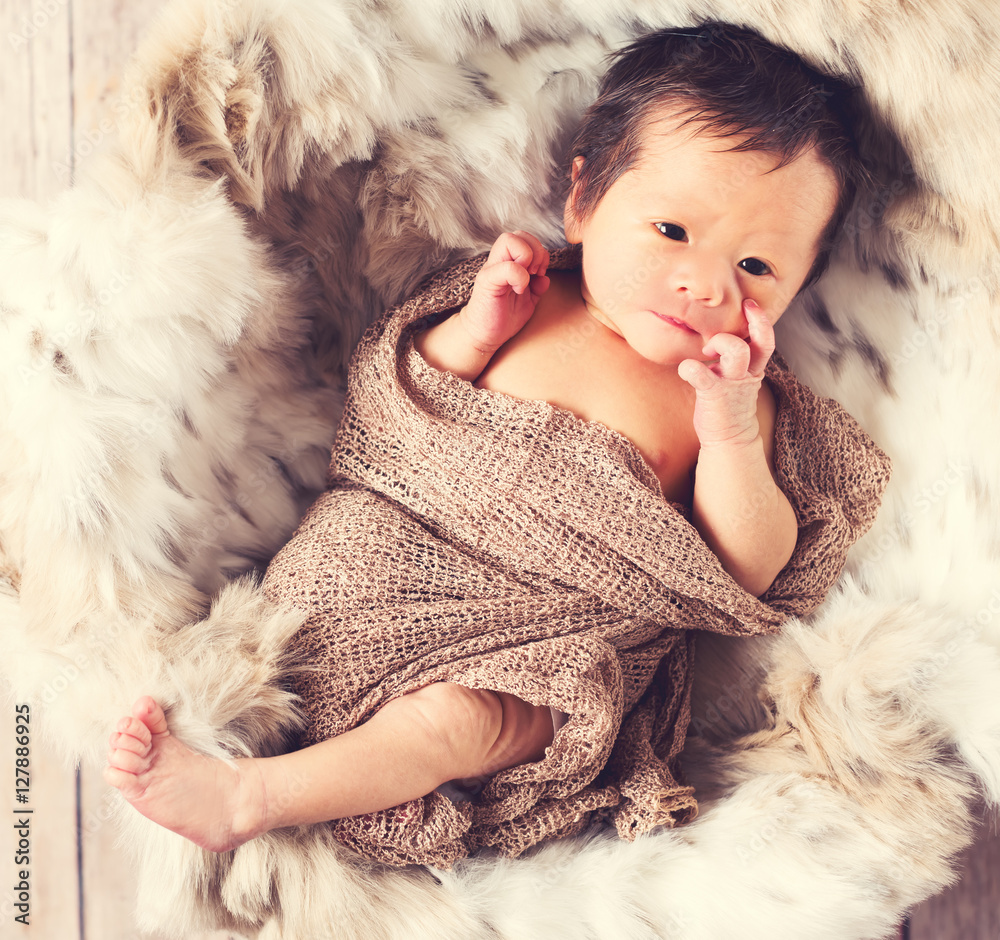 Newborn baby boy in a basket