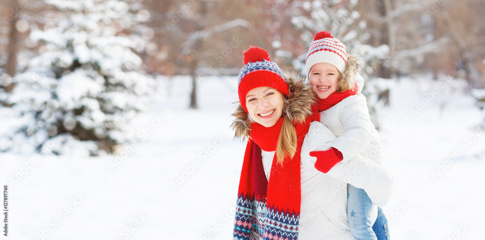 happy family mother and child daughter having fun, playing at wi