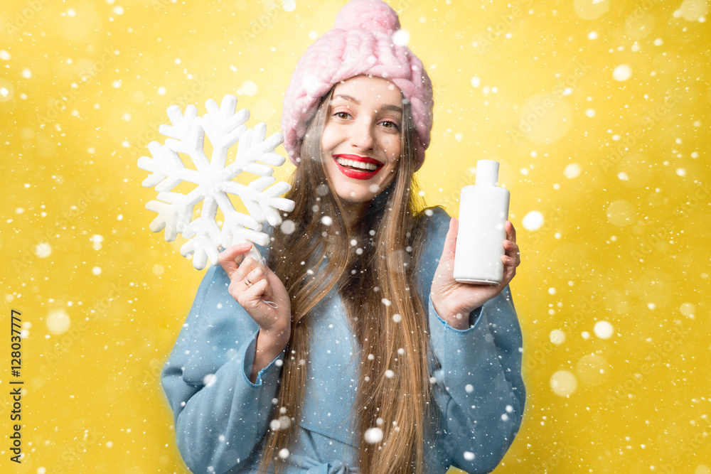 一个美丽女人的彩色冬季肖像，上面有护发素或洗发水和雪花