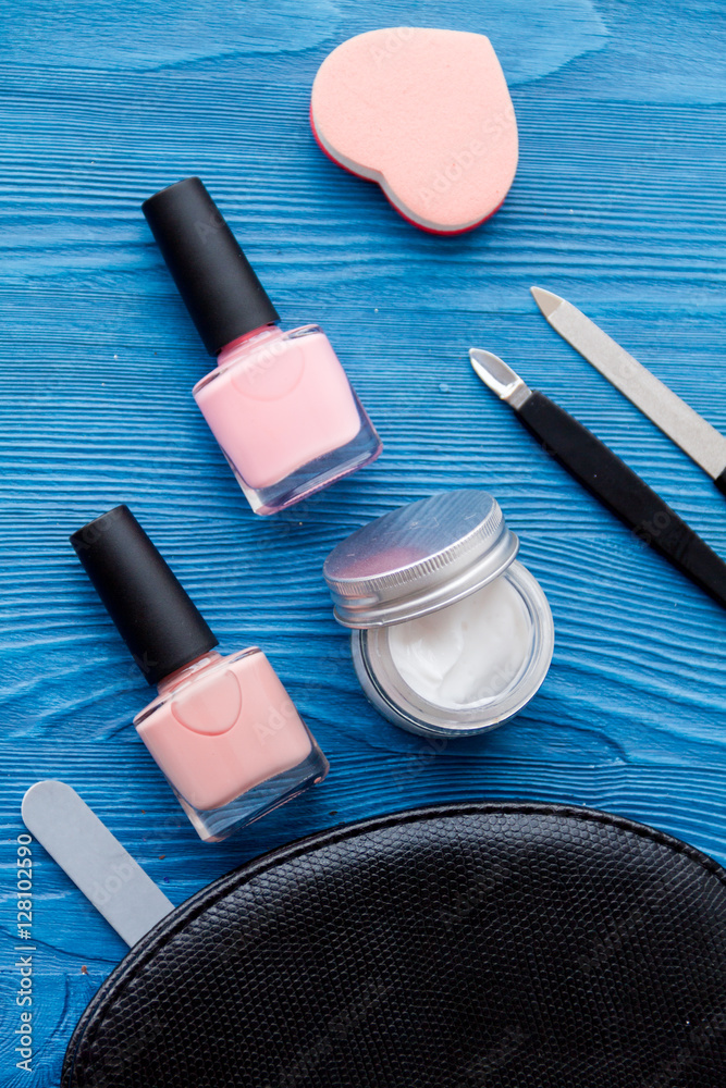 cosmetic and manicure set on wooden background top view