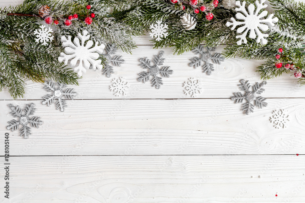 Christmas toys and spruce branches on wooden background top view